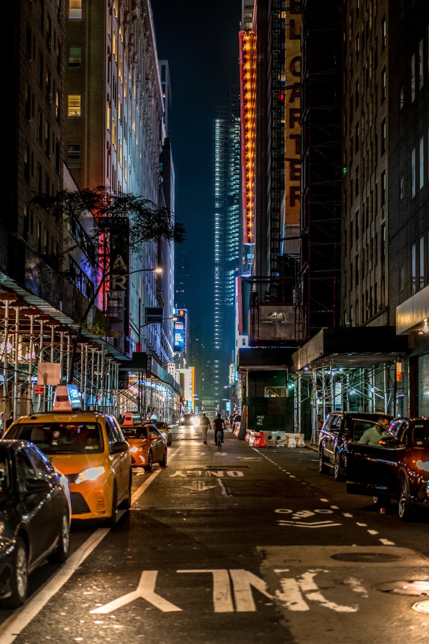 New York street at night with taxis and illuminated buildings