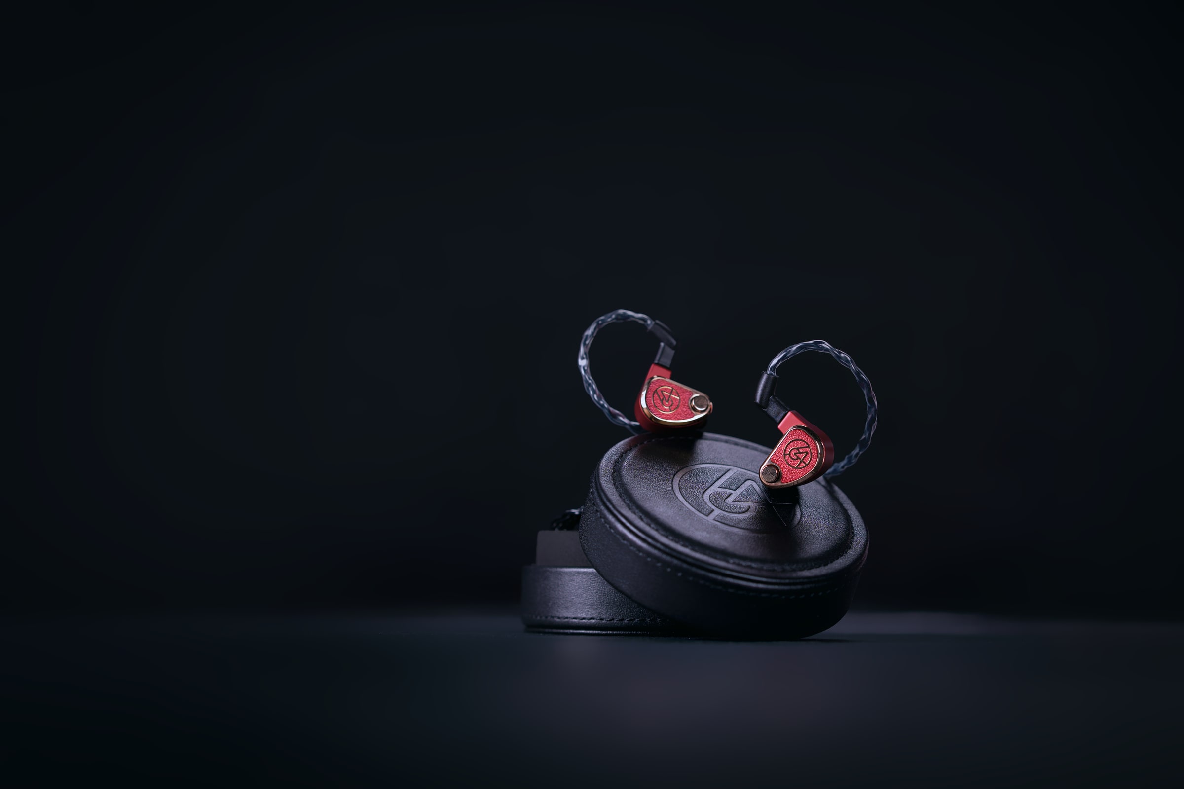 64 Audio in-ear monitors on a black studio pedestal