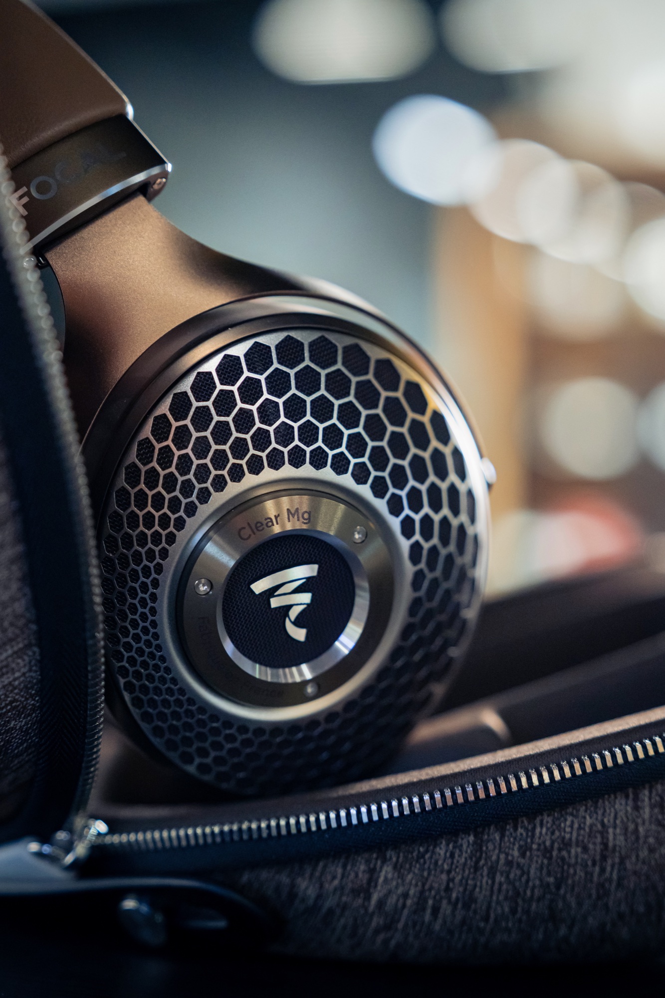 Focal Clear Mg earcup in its case, with the metallic grille and model mark in focus